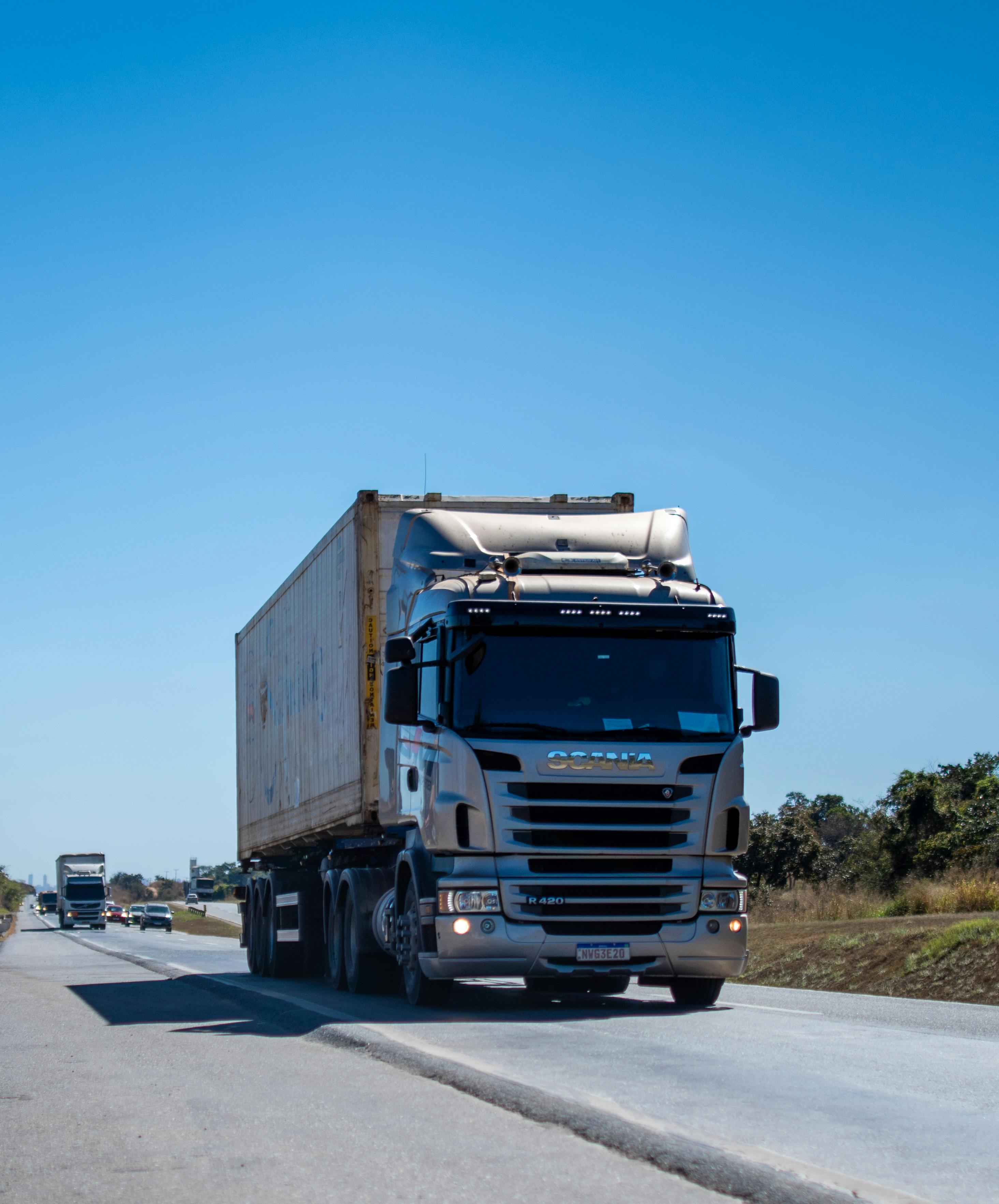 Professional driver securing cargo with safety straps and proper equipment